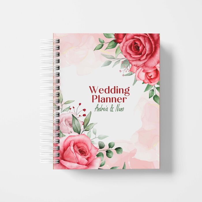 Um caderno, agenda, diário ou planner de casamento com um design floral com rosas cor de rosa na capa, intitulado 