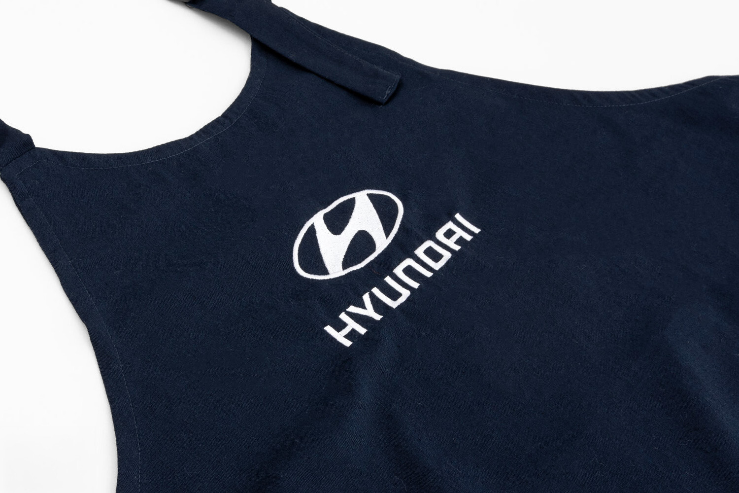 blue bib apron with embroidered logo