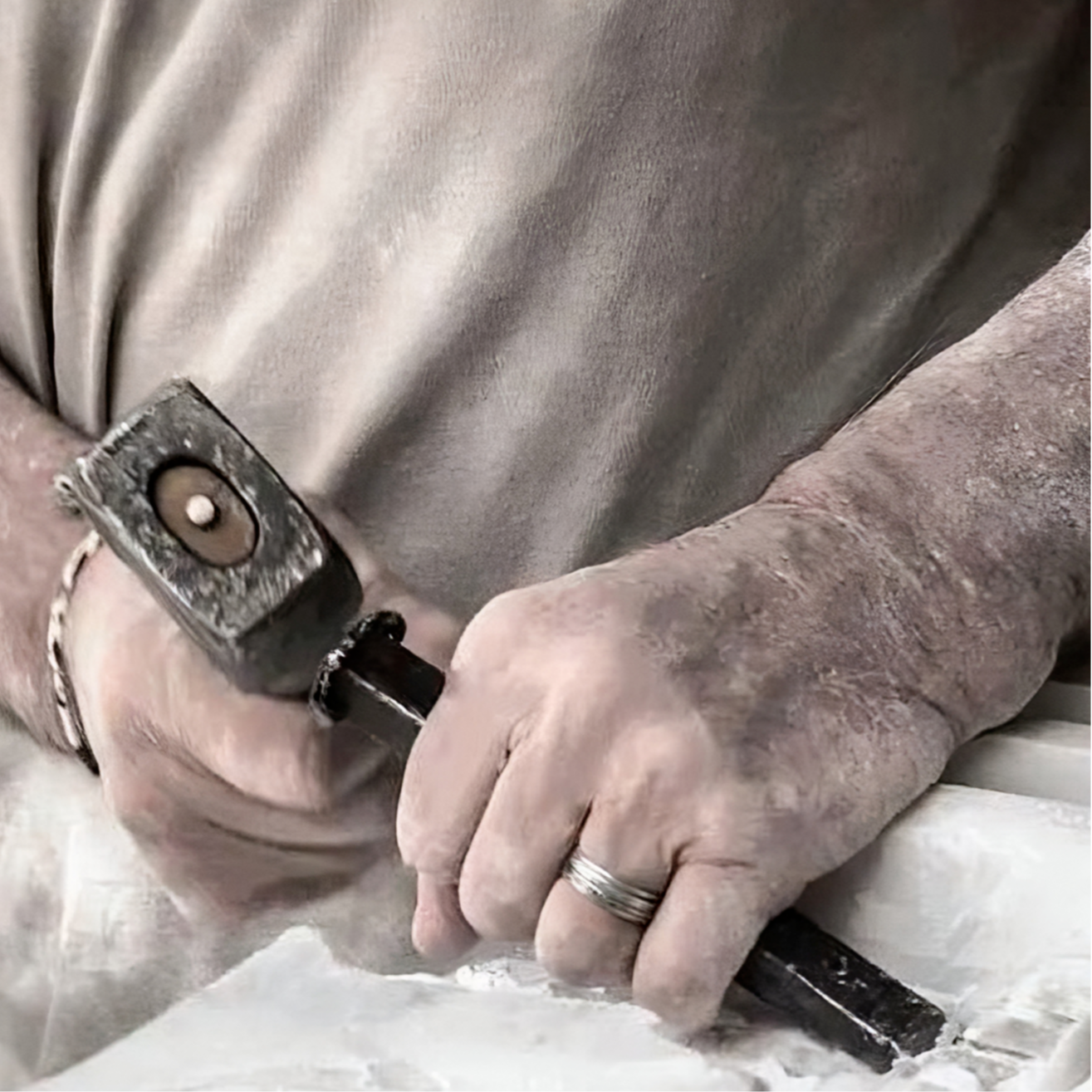 Artisan shaping natural stone elements for a bespoke MAMOA furniture piece