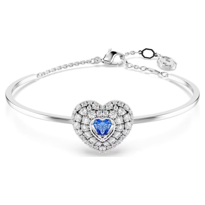 Pulseira prateada Swarovski com um coração com cristais incolores e uma azul no centro.