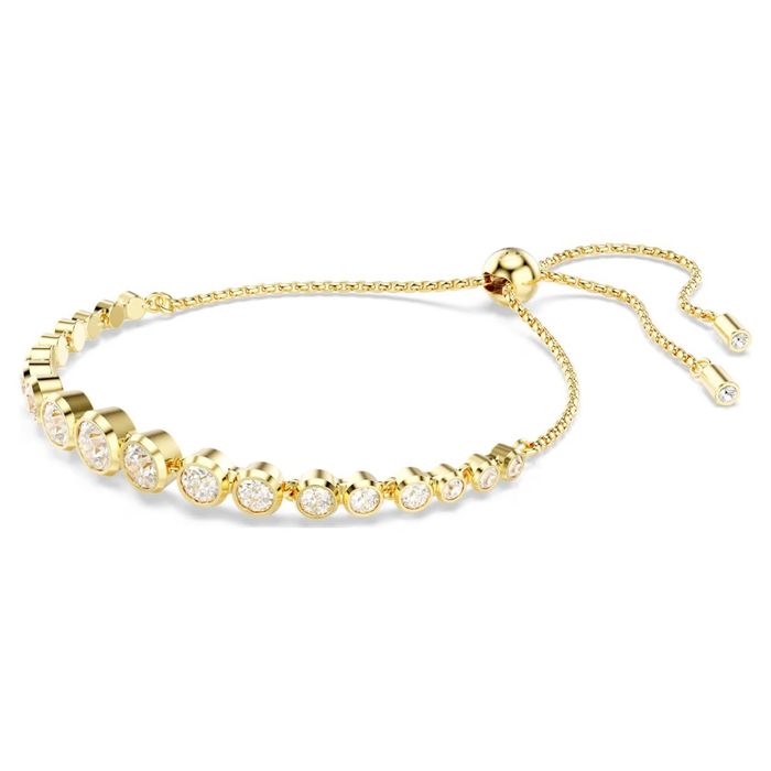 Pulseira dourada Swarovski, em vista de lado, com cristais incolores e um fecho em bola deslizante.