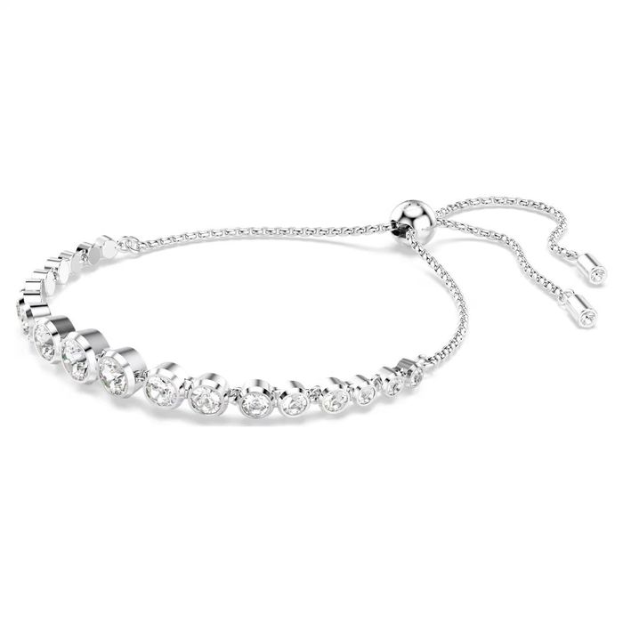Pulseira prateada Swarovski, em vista de lado, com cristais incolores e um fecho em bola deslizante.