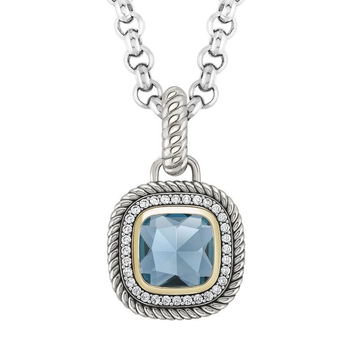 Colar com medalha Tashi com uma zircónia azul no centro e uma linha dourada e pedras à volta.