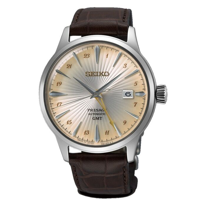 Relógio masculino Seiko de bracelete pele e caixa prateada, com mostrador redondo de tom champanhe.