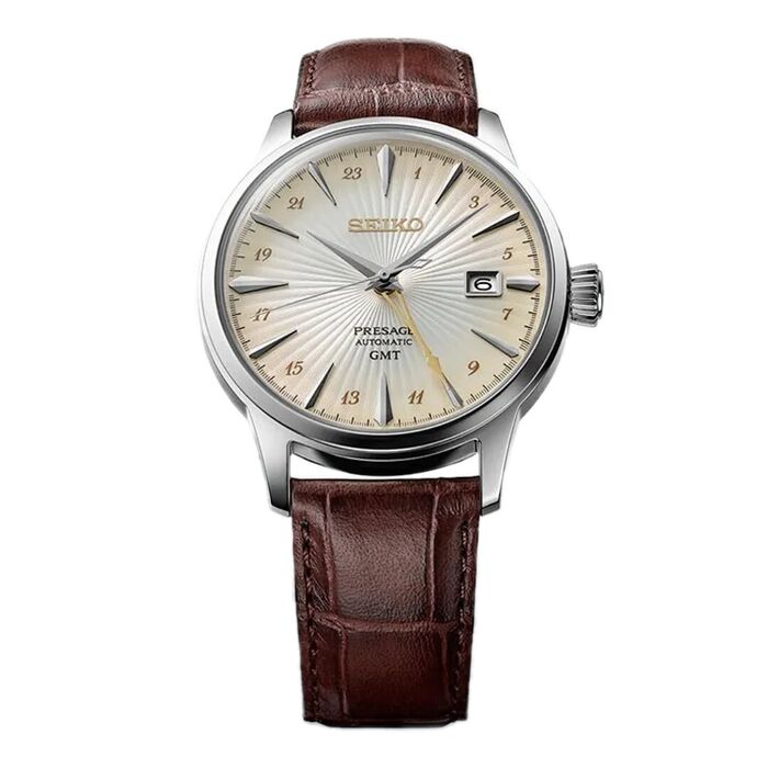 Relógio masculino Seiko de bracelete pele e caixa prateada, com mostrador champanhe e calendário.