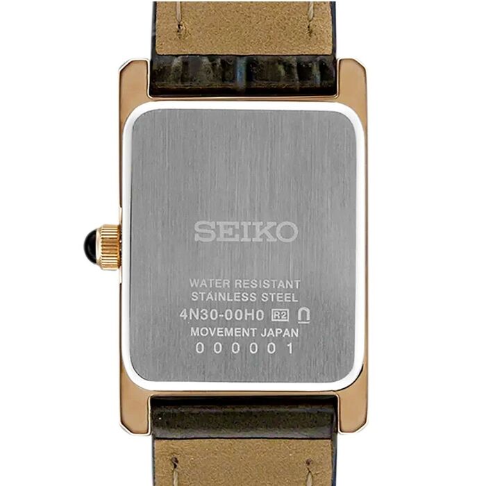 Vista traseira de relógio Seiko feminino, com caixa quadrada rose gold, mostrando a tampa prateada.