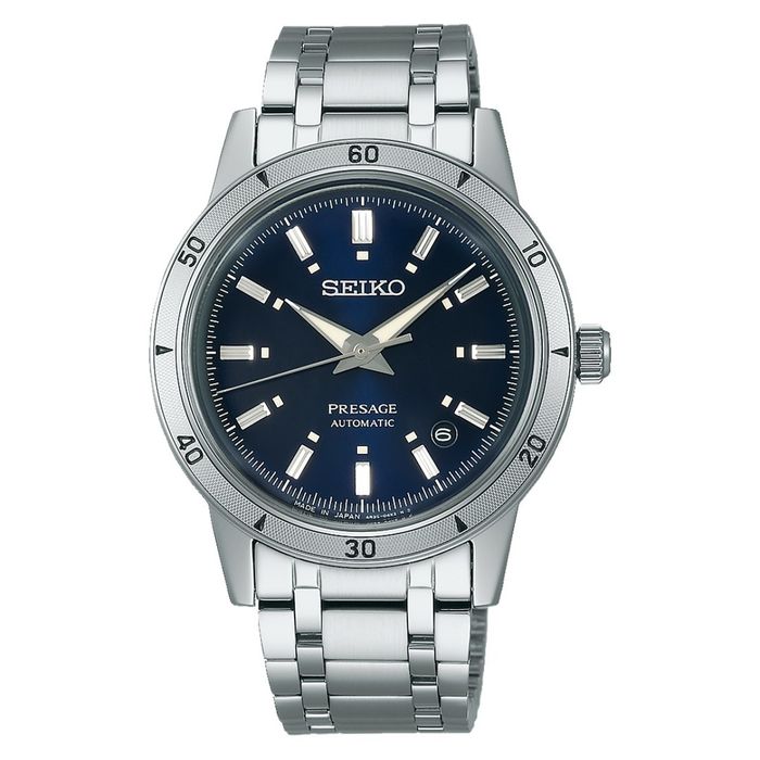Relógio Seiko de bracelete e caixa circular prateadas com um mostrador azul e calendário.