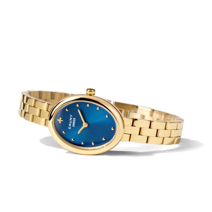 Relógio de pulso dourado oval com mostrador azul, marcadores em pontos e bracelete metálica