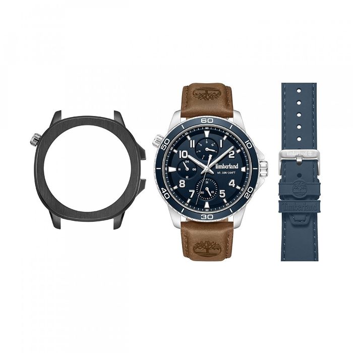 Relógio Timberland de bracelete castanha e mostrador azul com bracelete azul e caixa preta ao lado.