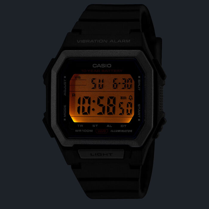 Relógio Casio digital com bracelete  caixa preta em resina, com luz laranja no mostrador.