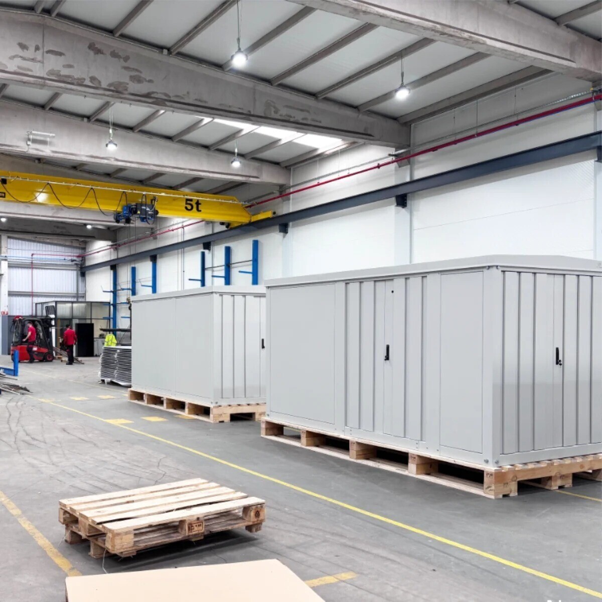 Two large fully assembled electrical cabinets for photovoltaic parks, ready for shipment, inside the assembly warehouse, showcasing turnkey manufacturing by V Laser On.