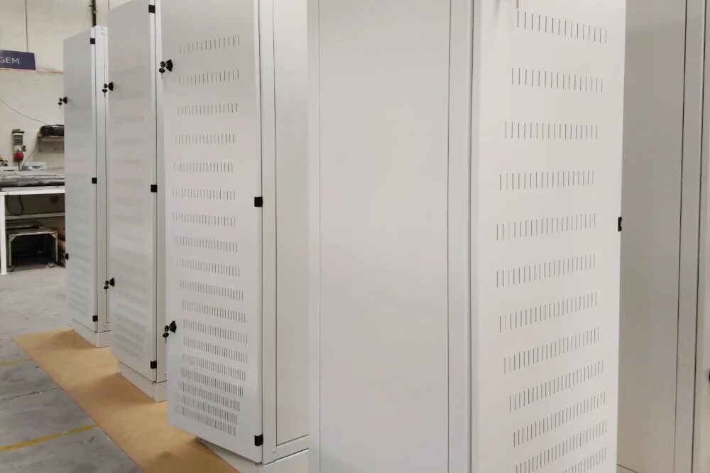 Fully assembled electronic server cabinets on assembly line, ready for shipment to clients, showcasing V Laser On turnkey manufacturing in Portugal