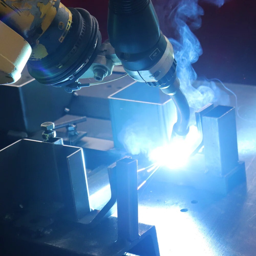 Close-up of robotic welding on steel structure, highlighting precision and automation in metal fabrication at V Laser On in Portugal
