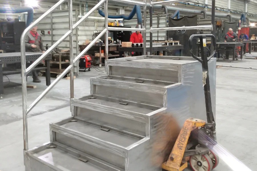 Metal stair structure for civil construction project, prepared and placed on pallet, warehouse in the background, V Laser On Portugal