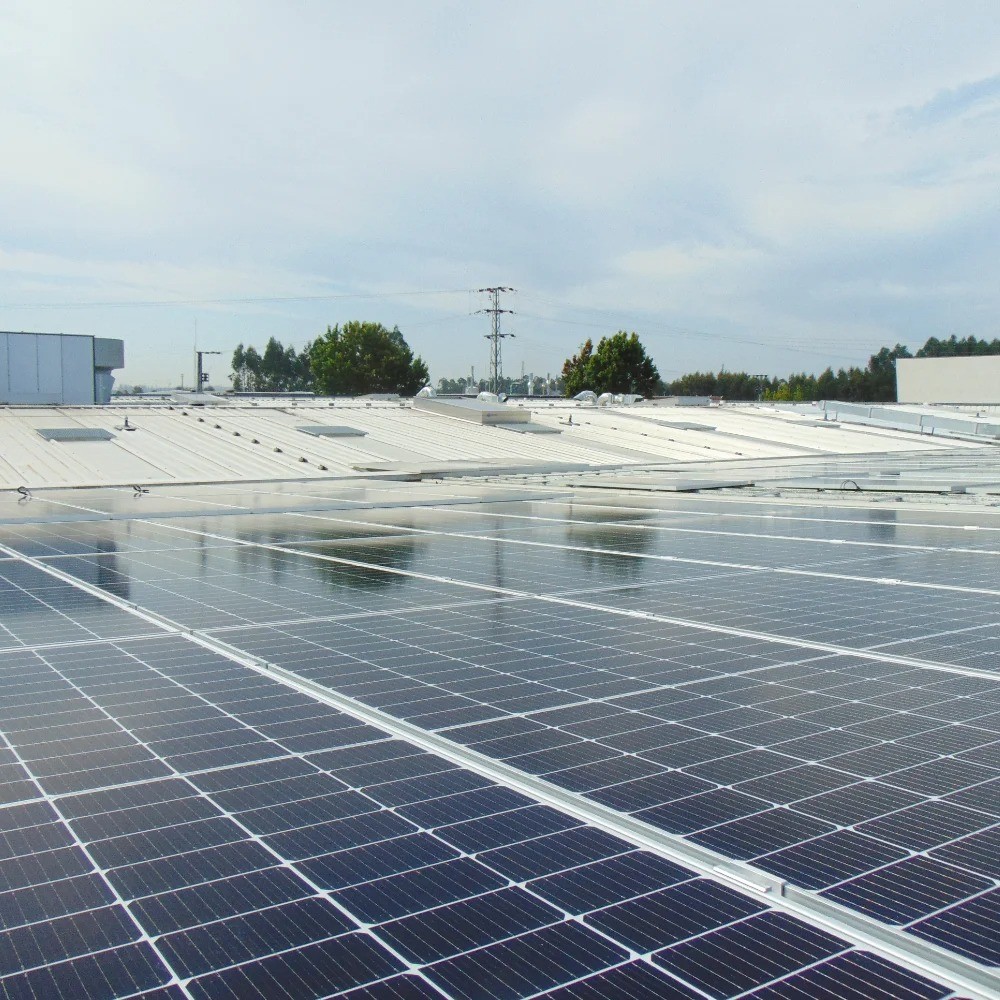 Solar photovoltaic panels installed on the roof of V Laser On factory in Porto, Portugal, generating renewable energy and supporting sustainable industrial operations