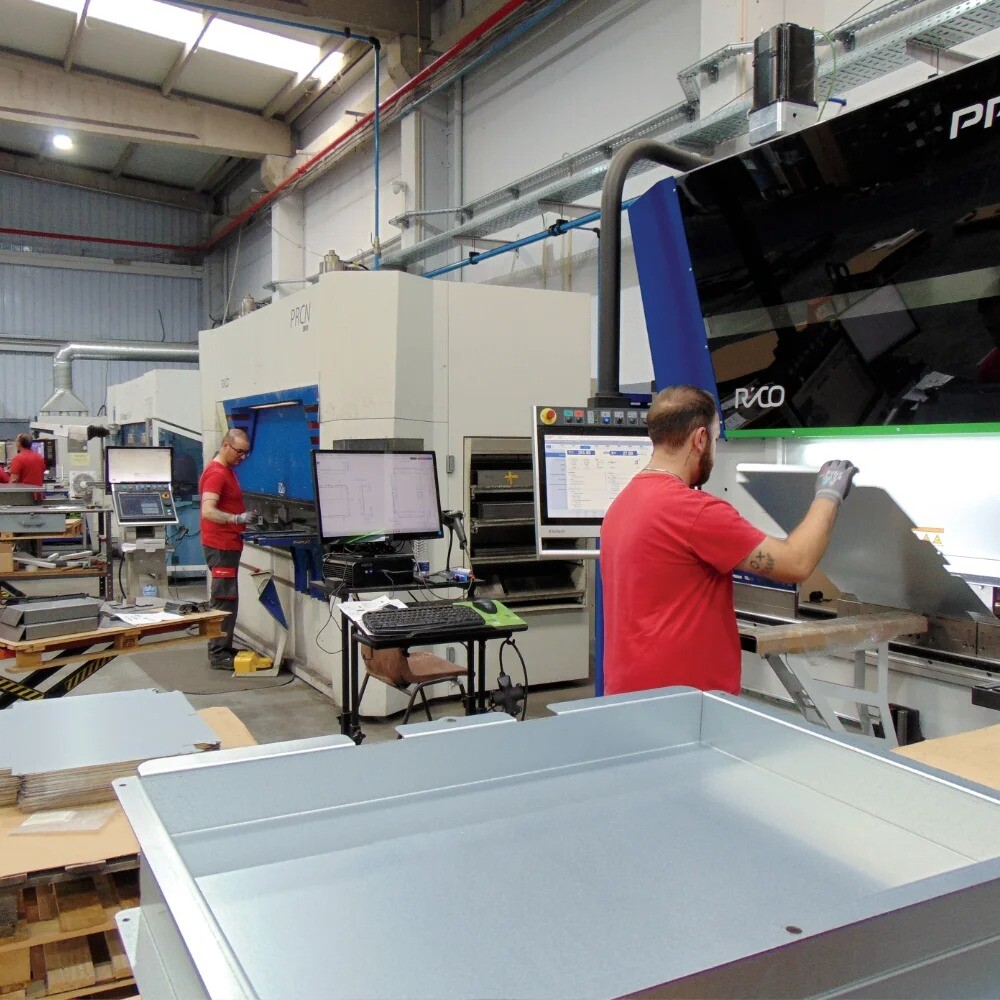 Three bending machines in a row at V Laser On workshop in Porto Portugal, with operators forming metal components, showcasing industrial sheet metal bending and precision fabrication