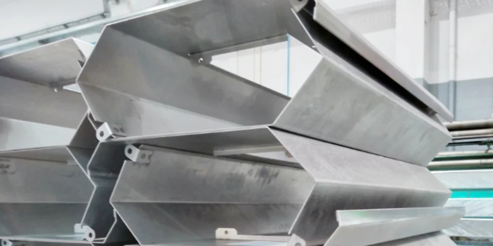 Bending metal structures stacked on a pallet at V Laser On workshop in Porto Portugal, ready for assembly or further processing, showcasing industrial sheet metal bending and handling workflow