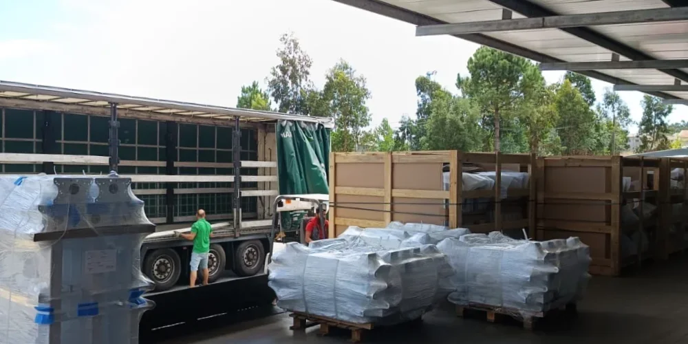 Loading dock at V Laser On in Porto Portugal with pallets of finished industrial components ready and a truck being loaded, showcasing efficient shipping and logistics workflow