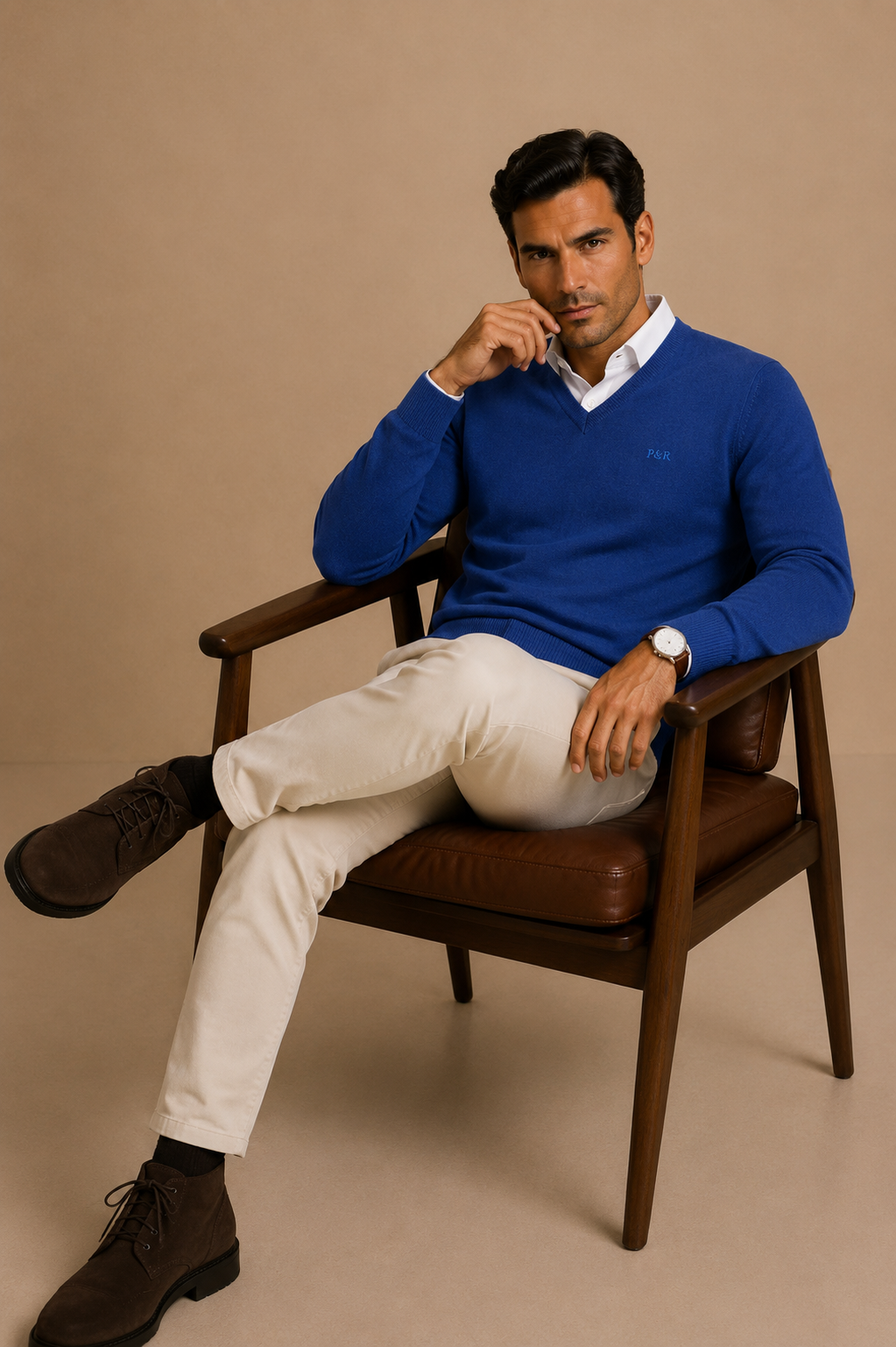 A man dressed in a timeless cardigan, chinos, and his dog.